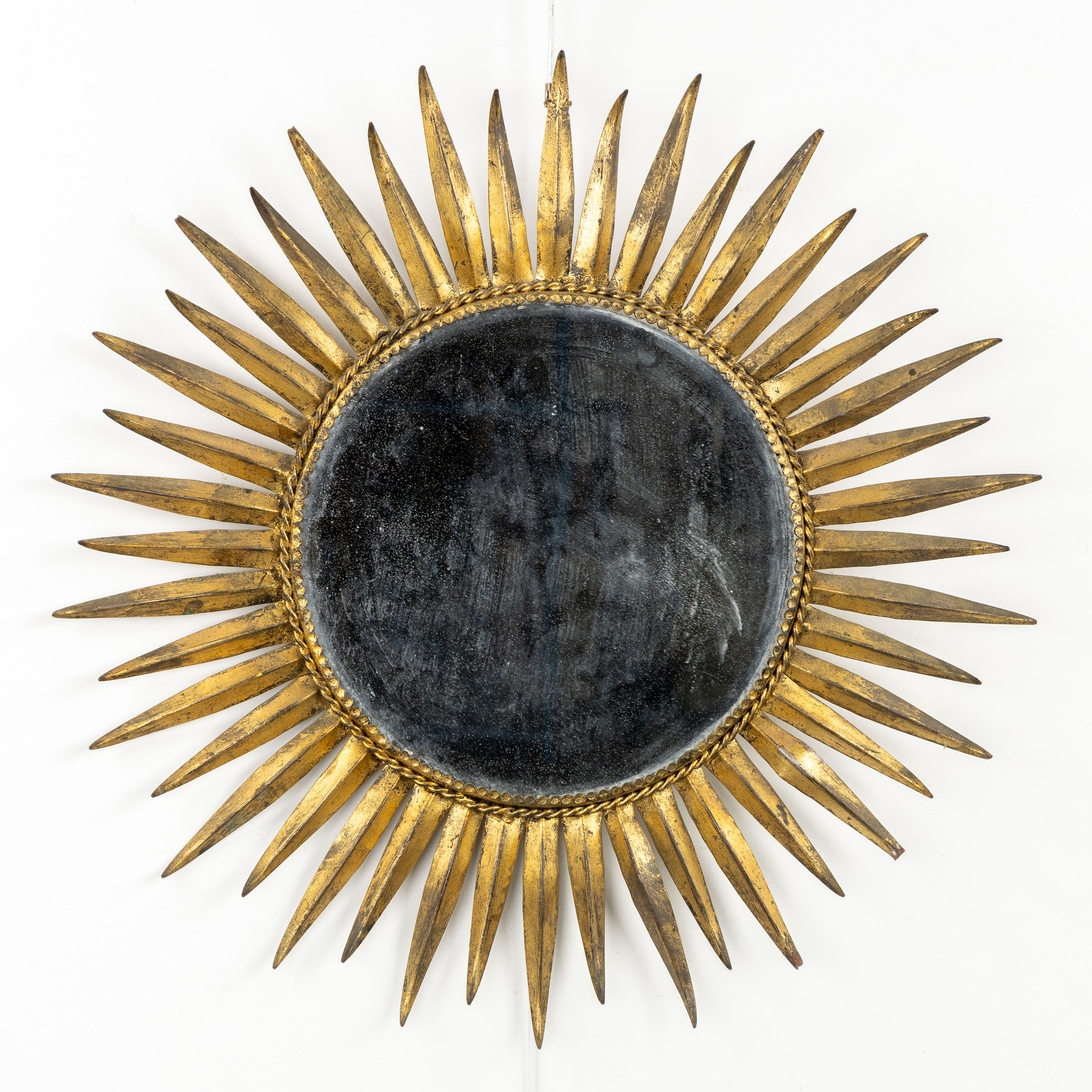 A Mid-Century Sunburst Mirror, Gilt metal. Circa 1970. (H:60 cm)